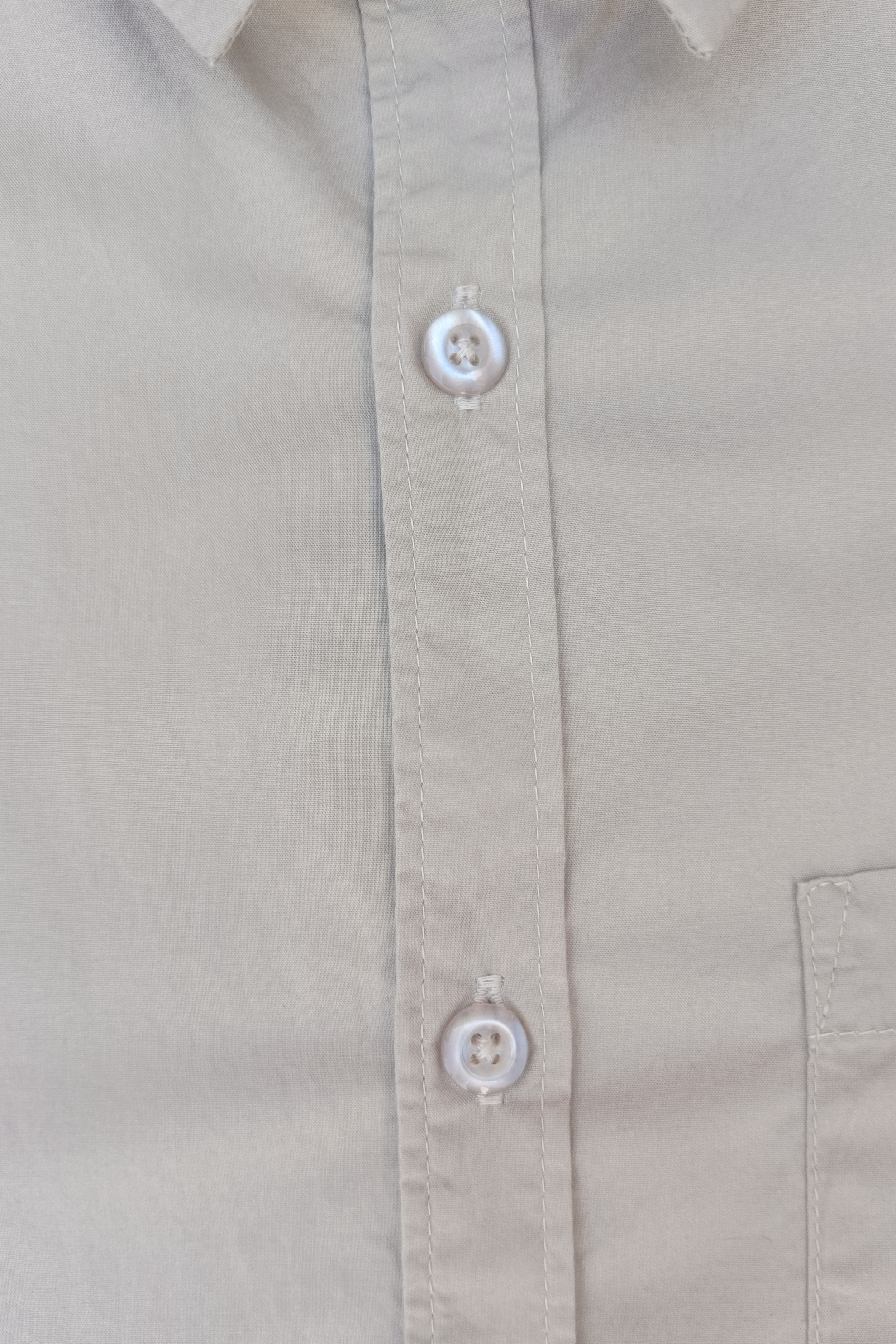Close-up of a beige shirt with buttons
