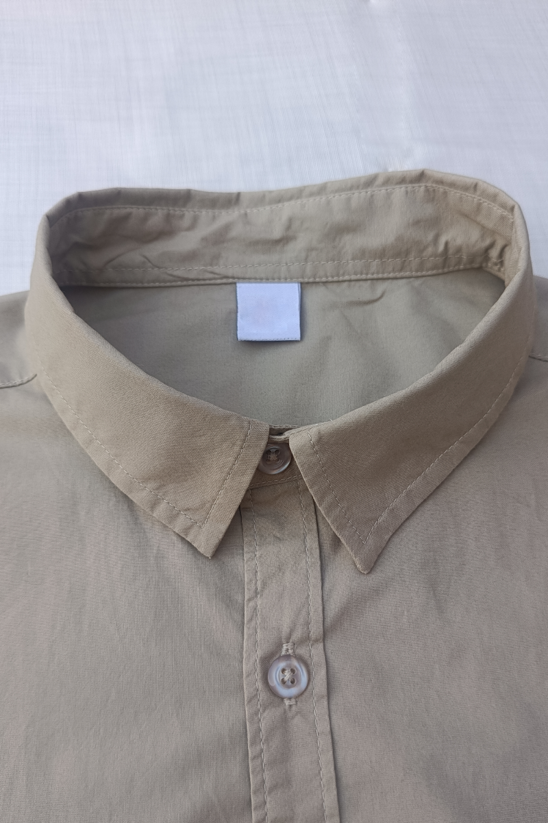 Beige shirt collar with a tag on a white background