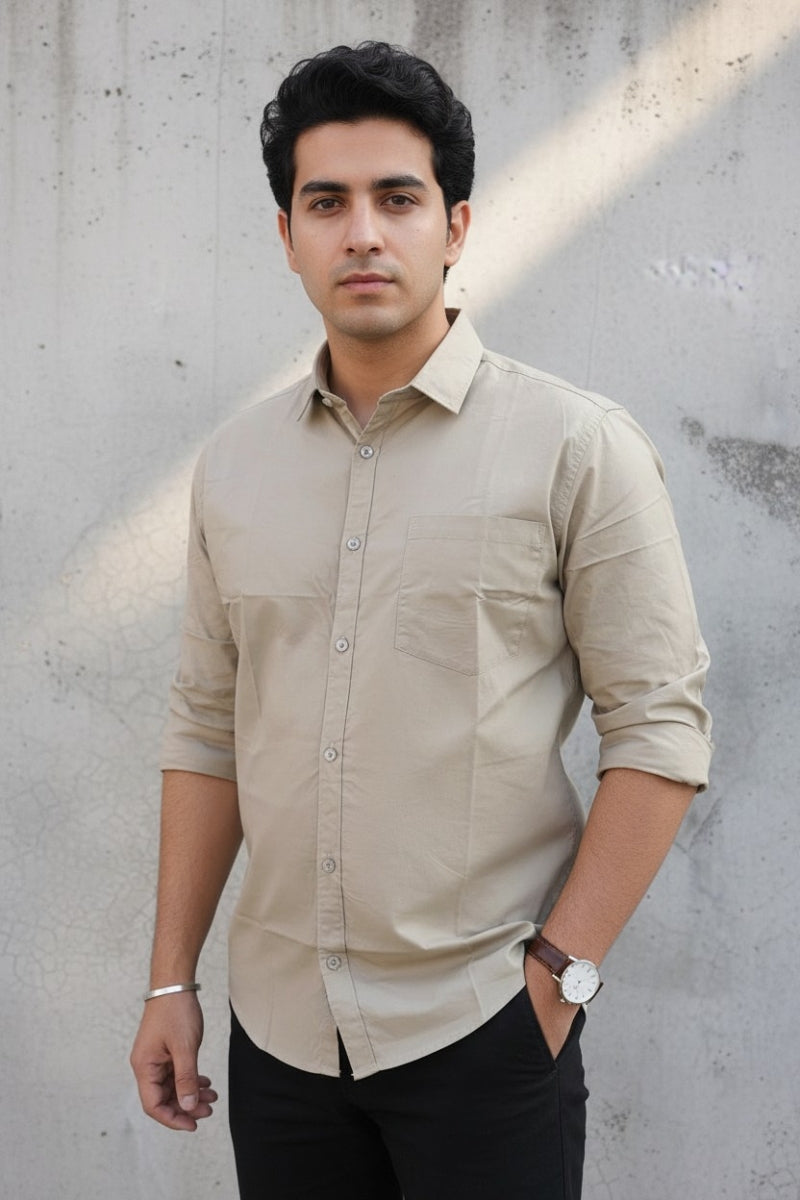 Men's beige relaxed fit cotton shirt with chest pocket front view by Quiet Soul worn by model against grey concrete background