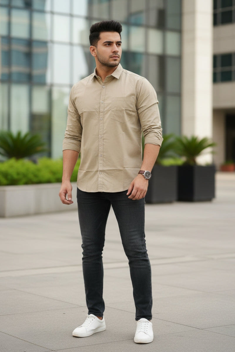 Men's beige relaxed fit cotton shirt with chest pocket right front view by Quiet Soul worn by model against a budling background